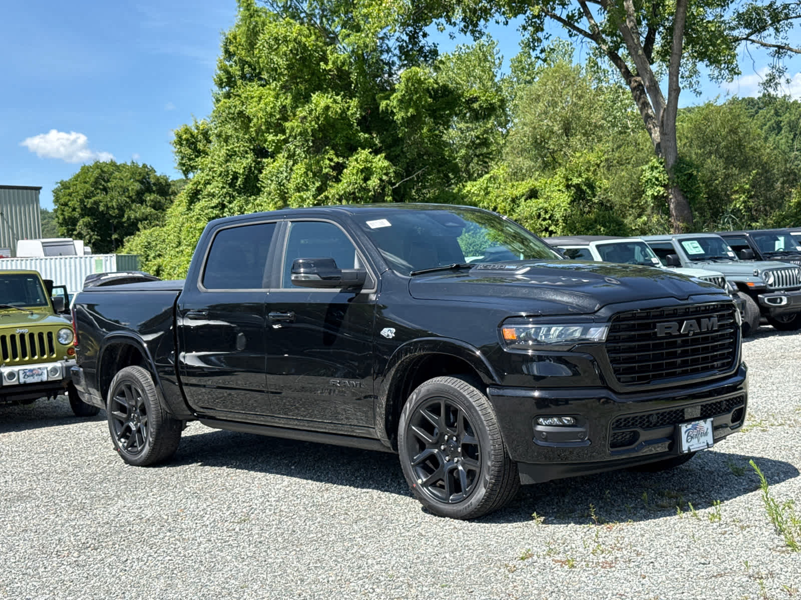 2026 RAM 1500 Laramie in Diamond Black Crystal Pearlcoat — front three-quarter view