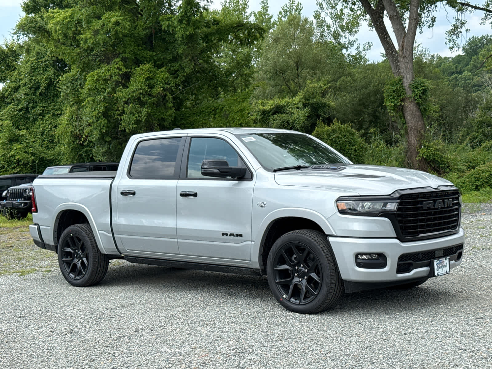 2026 RAM 1500 Laramie in Silver Zynith — front three-quarter view